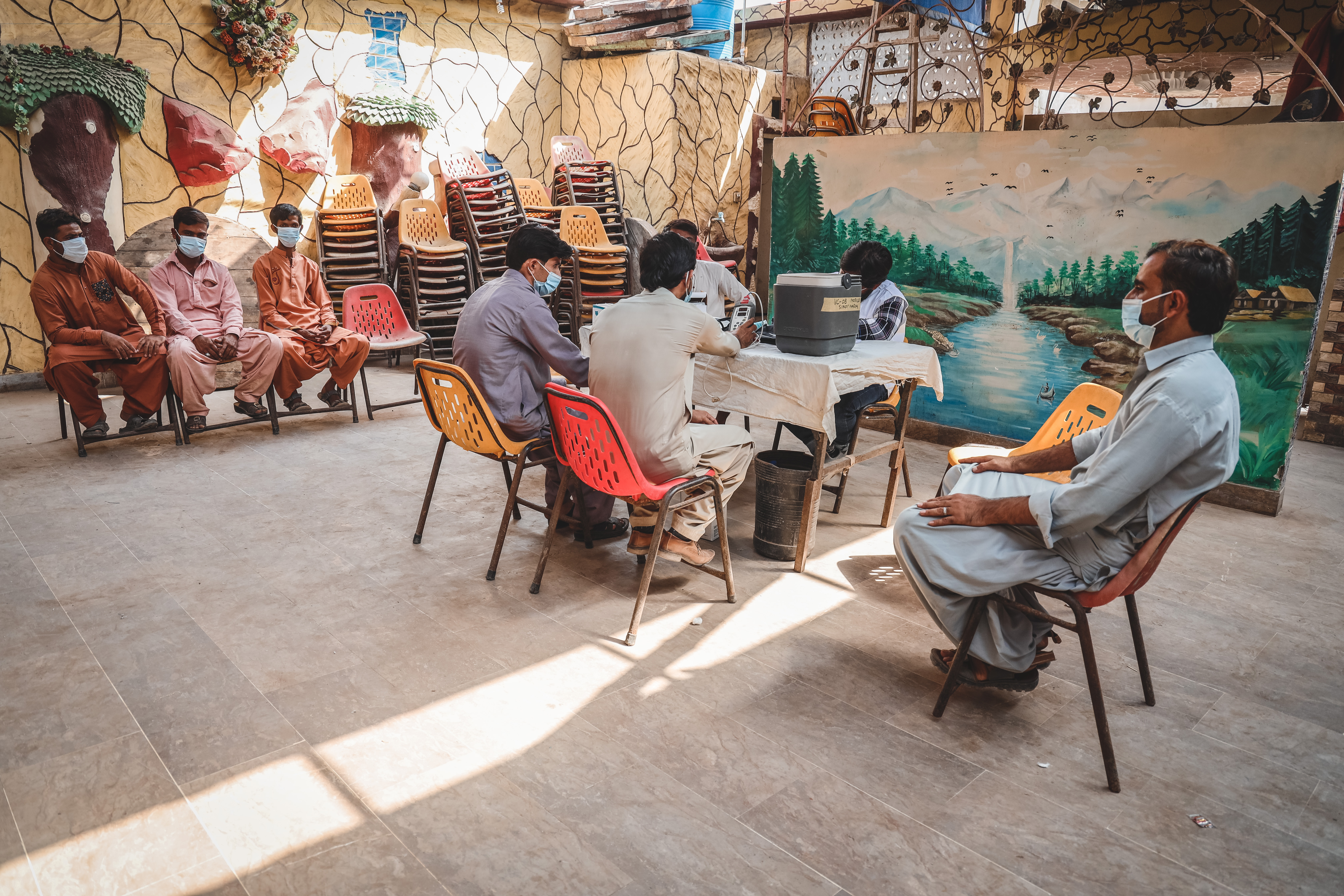 Patients waiting to get vaccinated against COVID-19 at MSF’s mobile clinic in Machar Colony, Karachi.