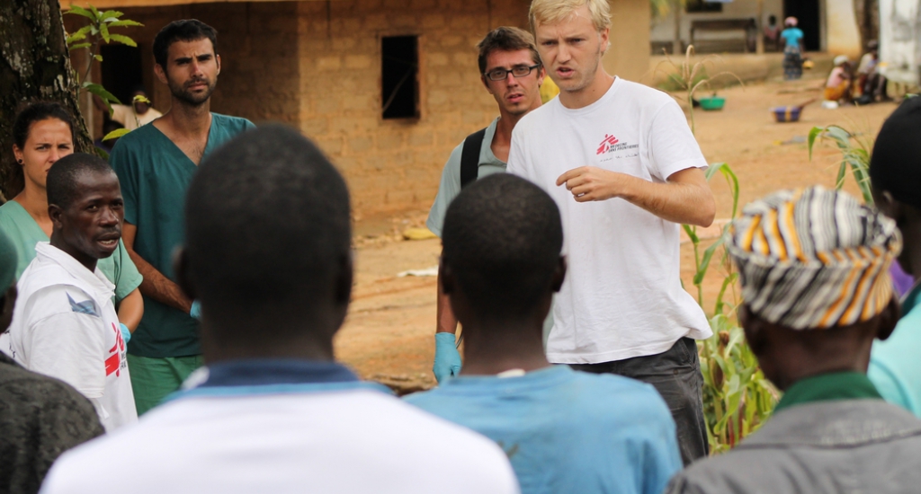 © Martin Zinggl/MSF -Jesse while doing a health promotion before the teams are starting their work. He talks about Ebola, involves the local villagers by asking them questions and giving them time to ask questions.